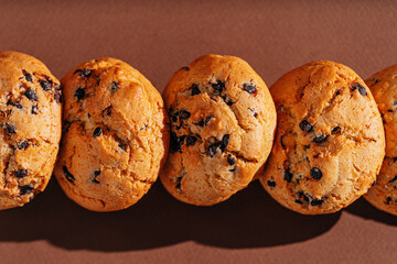 chocolate chip cookies close-up on brown background