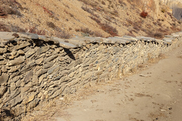 stone fence along the road near the village of Ranipauwa. Mustang District, Nepal