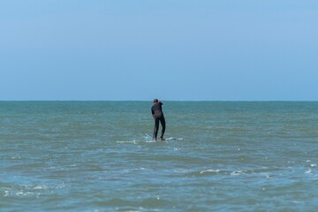Man practicing Stand up paddle in the sea