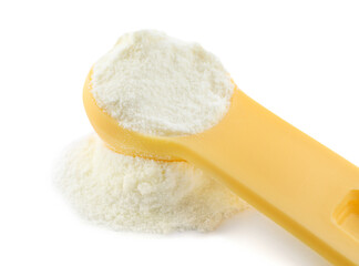 Powdered infant formula and measuring scoop on white background, closeup. Baby milk