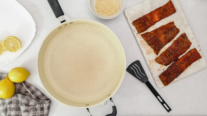 Smoked paprika roasted salmon  recipe. Marinated fish pieces close up on cutting board ready to be...
