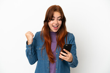 Fototapeta premium Young redhead woman isolated on white background surprised and sending a message