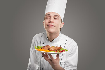 Cook enjoying scent of tasty dish