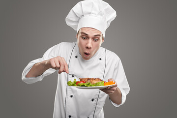 Funny male chef trying dish