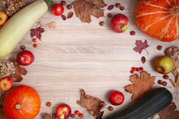 Autumn decor of pumpkins, apples and leaves on a wooden background. Thanksgiving or Halloween concept, seasonal offers. Flat lay autumn composition with copy space.