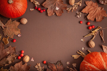 Autumn decor of pumpkins, apples and leaves on a wooden background. Thanksgiving or Halloween concept, seasonal offers. Flat lay autumn composition with copy space.