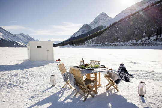 Table setting for luxury outdoor dining on frozen alpine lake