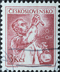 Czechoslovakia Circa 1954: A postage stamp printed in Czechoslovakia showing a portrait of a chemist during laboratory analysis - obrazy, fototapety, plakaty