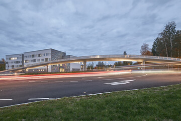 The roundabout in the Matinkyla neighborhood of Espoo, Finland. The modern pedestrian bridge over the roundabout. On the background the brand new school building.