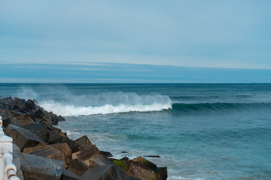 Sea waves and rocks. Seasore. Basque country landscape. Rainy weather. Blue water and sky.
