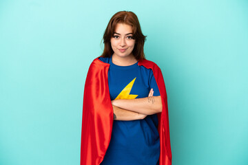 Young caucasian woman isolated on white background in superhero costume with arms crossed