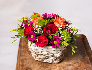 Fototapeta na wymiar Little bouquet of beautiful flowers lying on a chair