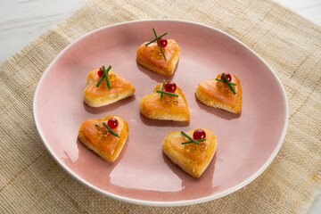 Salmon canape with heart shape and olive oil pearls. 