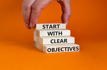 Start with clear objectives symbol. Wooden bloks with words 'Start with clear objectives'....
