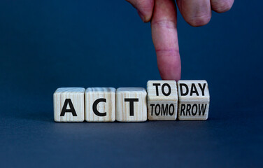 Act today not tomorrow symbol. Businessman turns wooden cubes, changes words act tomorrow to act today. Beautiful grey table, grey background. Business, act today or tomorrow concept, copy space.