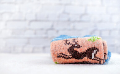 Christmas socks with deer close-up on bricks background. Copy space