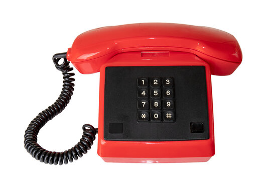 Vintage telecommunication technology. Close-up of a old red telephone with black cable and buttoms. Suitable for contact exchange and call centre. Retro phone receiver.