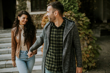 Fototapeta premium Young couple walking in autumn park