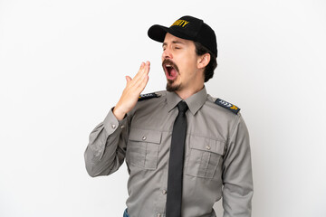 Young caucasian security man isolated on white background yawning and covering wide open mouth with hand