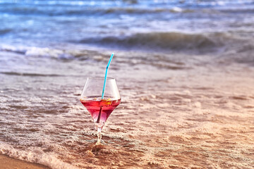 Wine glass with a cocktail by the sea.