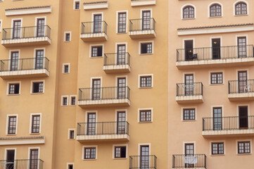 Fototapeta na wymiar facade of a community with multiple balconies and windows of different sizes