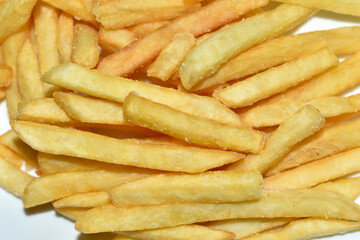 Juicy yellow delicious fries on a white plate