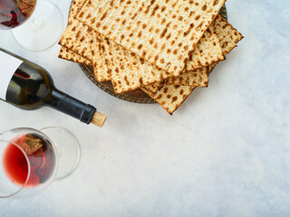 Jewish Easter. Background. A stack of traditional Easter bread - matzah, a bottle of red wine and glasses of wine. Traditional holiday treat. Religion, Judaism, traditions, rituals.
