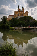 Fototapeta na wymiar Panorama of famous 11th century Baroque Abbey (Stift Melk) with views of the Danube River on a rocky outcrop, Melk, Austria