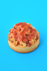 apple caramel tartlet on blue background