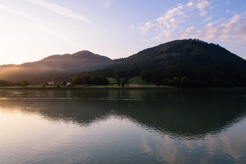 Scenic view of beautiful mountains with fog along the Danube river at sunrise, Grein, Austria