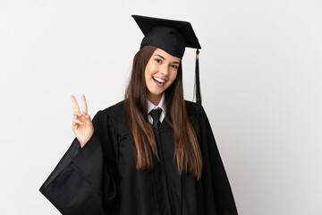 Teenager Brazilian university graduate over isolated white background smiling and showing victory sign