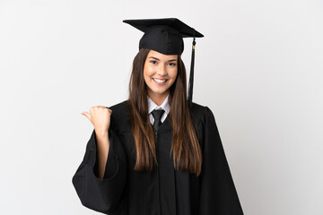 Teenager Brazilian university graduate over isolated white background pointing to the side to present a product