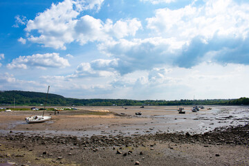 Fototapeta na wymiar Red Wharf Bay, Anglesey, Wales. Beautiful seascape of sand beach with small boats at low tide. Landscape aspect shot