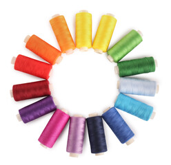 Frame of colorful sewing threads on white background, top view. Space for text