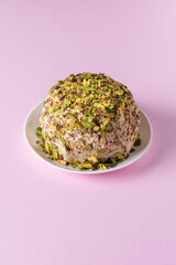 Halva with chopped pistachios on pink with copy space