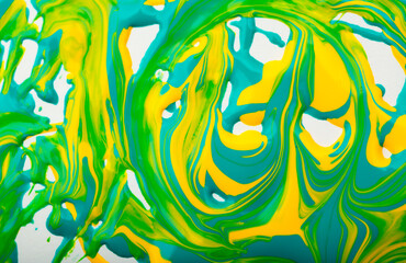 Beautiful abstract background with spots of blue, pink, green, yellow and purple paint. Oil paint, flowing down the canvas, shimmers with galagrophic paints with neon illumination.