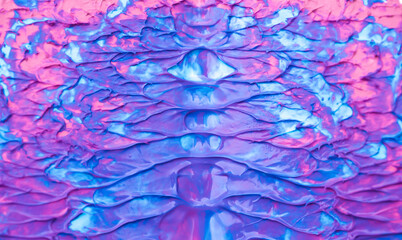 Beautiful abstract background with spots of blue, pink, green, yellow and purple paint. Oil paint, flowing down the canvas, shimmers with galagrophic paints with neon illumination.