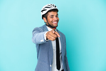 Young business Brazilian man with bike helmet isolated on blue background points finger at you with a confident expression