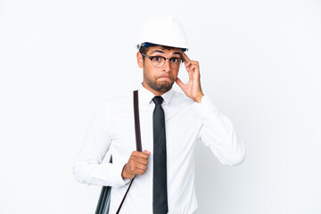 Architect brazilian man with helmet and holding blueprints thinking an idea