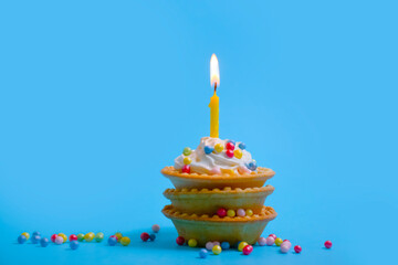 festive cake candle on a colored background
