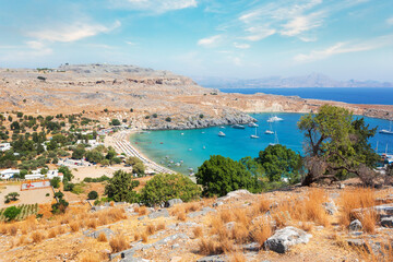 Fototapeta premium View from the hill of the Acropolis on the Mediterranean coast in the city of Lindos, Rhodes island, Greece
