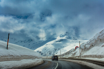 Road with one car and a lot of snow in the Alps. Switzerland, Europe

