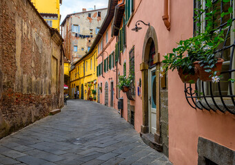 Fototapeta na wymiar Old cozy street in Lucca, Italy. Lucca is a city and comune in Tuscany. It is the capital of the Province of Lucca