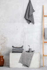 Organic waffle linen towels, bamboo toothbrushes, bathroom zero waste accessories in grey shades in contemporary bathroom interior. Daily body care, spa and wellness zero waste bathroom concept