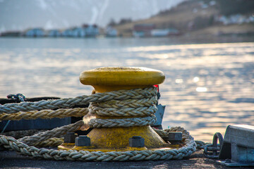 Closeup of a mooring rope and bollard on the quay