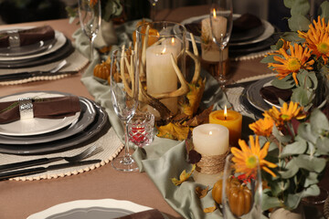 Table set with beautiful autumn decor for festive dinner