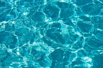 Abstract ripple wave and clear turquoise water surface in swimming pool, blue water wave for background and abstract design.