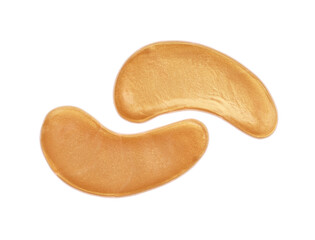 Golden under eye patches on white background, top view. Cosmetic product
