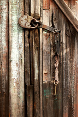 Old padlock on the old wooden door barn.