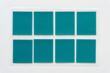 blank paper squares in teal on old paper